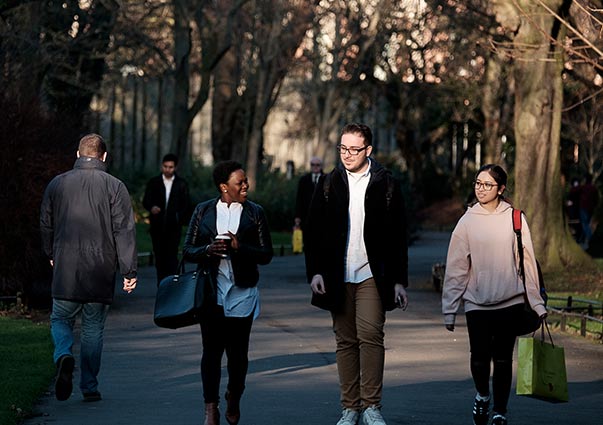 DIFC Students walking and smiling through a park