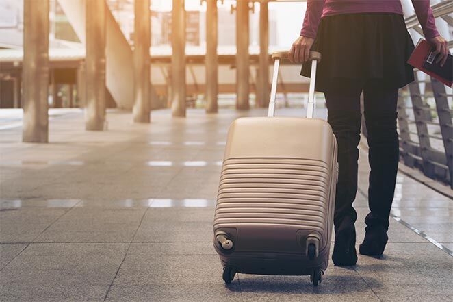 Woman pulling suitcase
