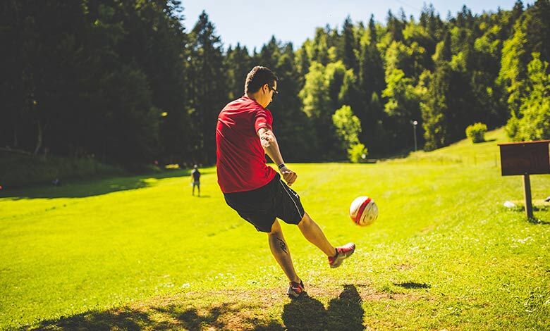 Man kicking a football