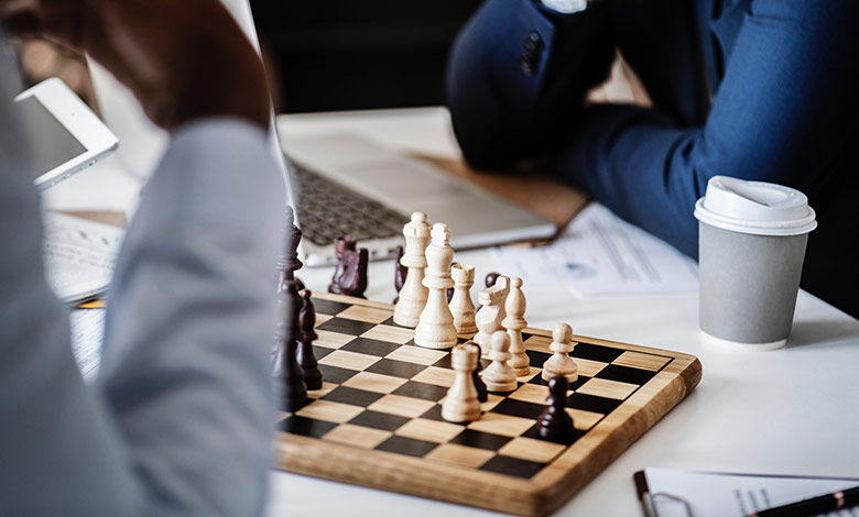 Chessboard with a laptop behind it