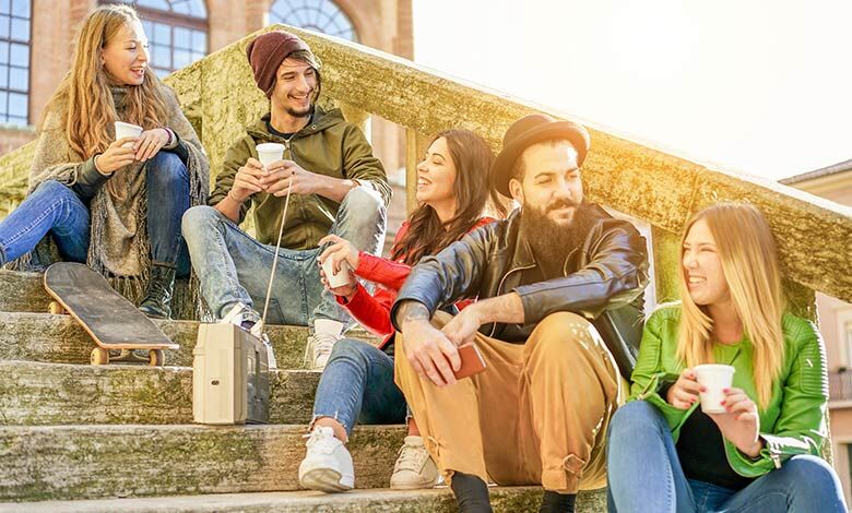 Students sitting on steps listening to a radio